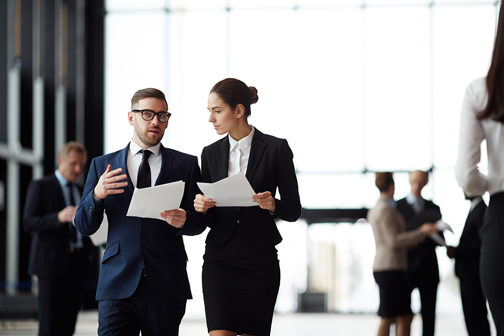 Two People Discussing Business in Professional Attire